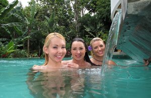 Amateur solo girl Kate covers her naked tits after getting in a swimming pool